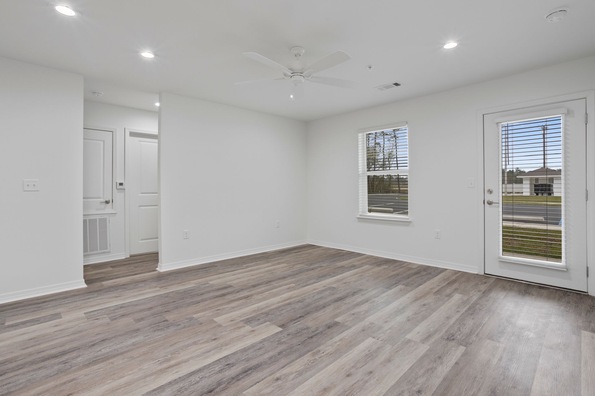 Photo of a living room with the hallway in the background