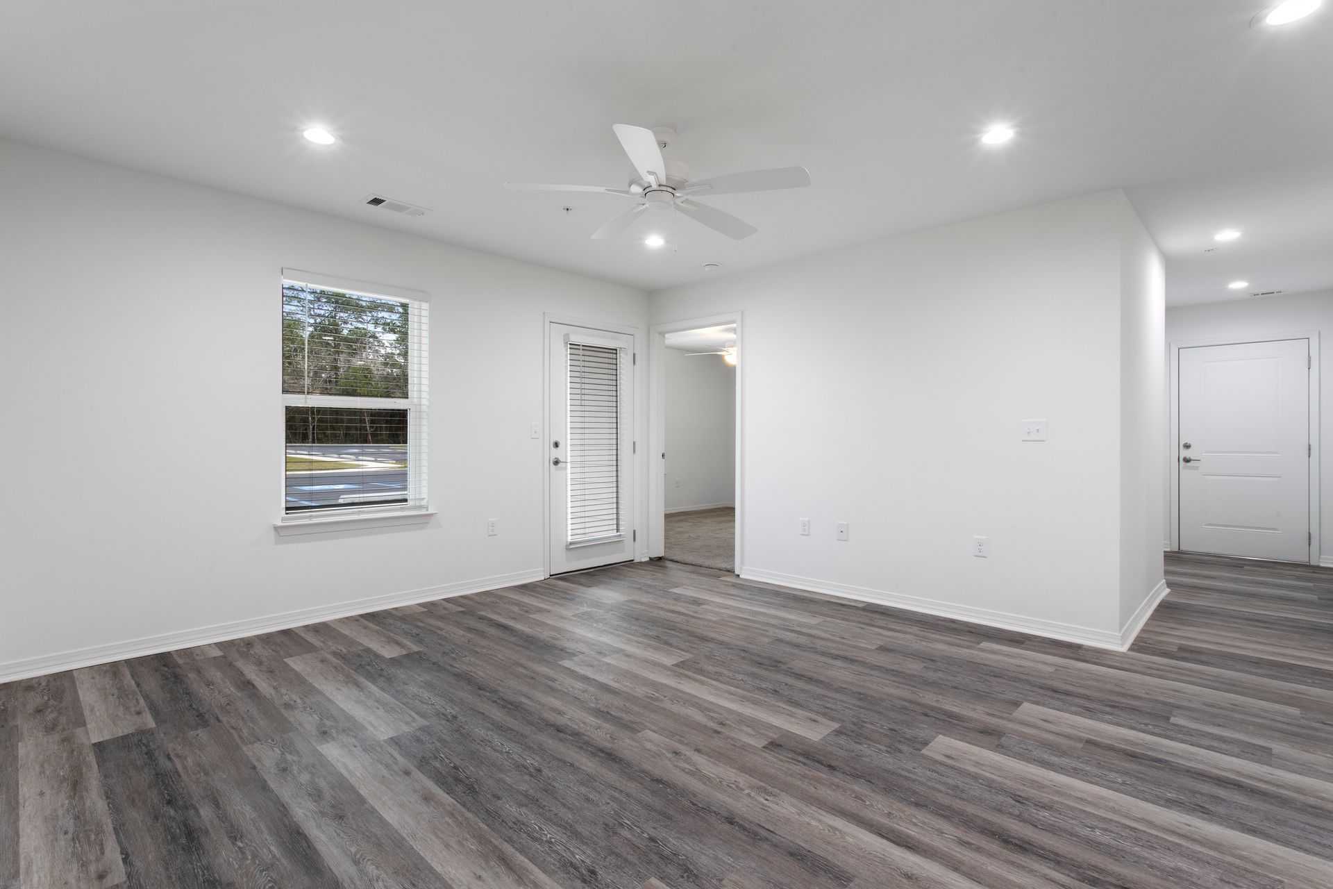 Photo of a living room with a ceiling fan and plenty of open space