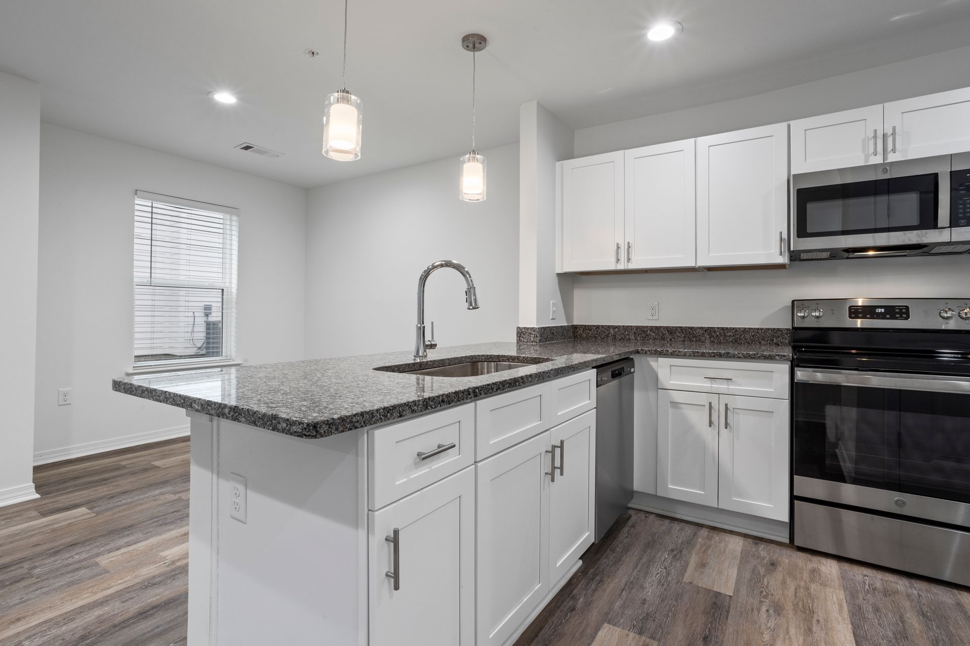 Photo of a kitchen sink with a barstool area