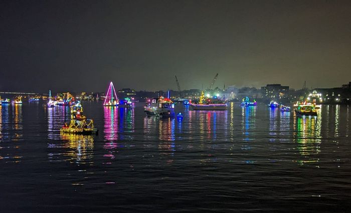 Holiday Boat Parade on the Potomac with boats lit up in holiday lights | Floating homes for sale