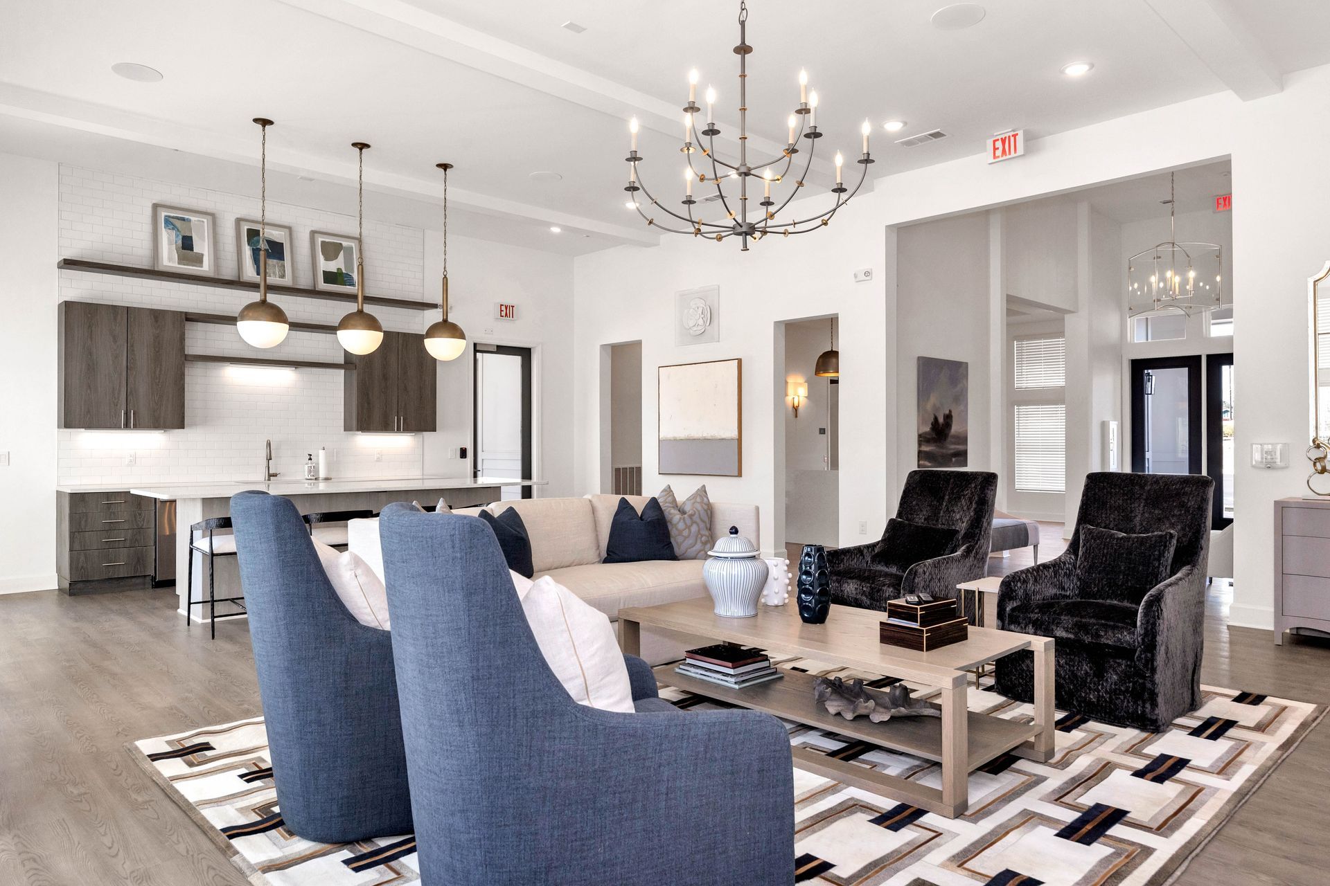 Stylish apartment living room with modern furniture and a kitchen in the background.