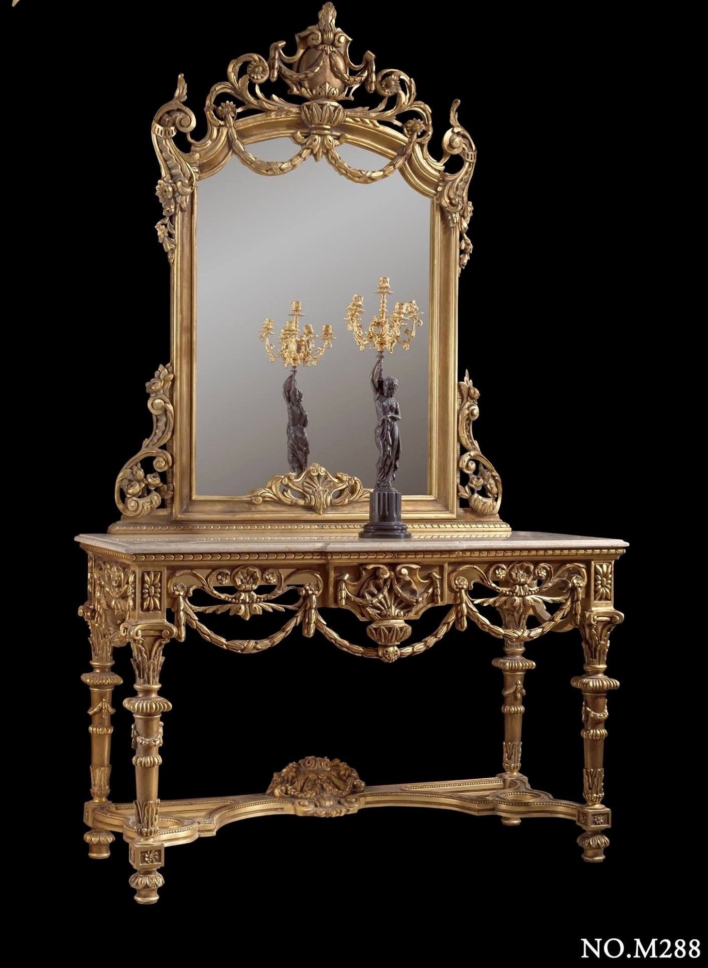 A table with a mirror and two candles on it