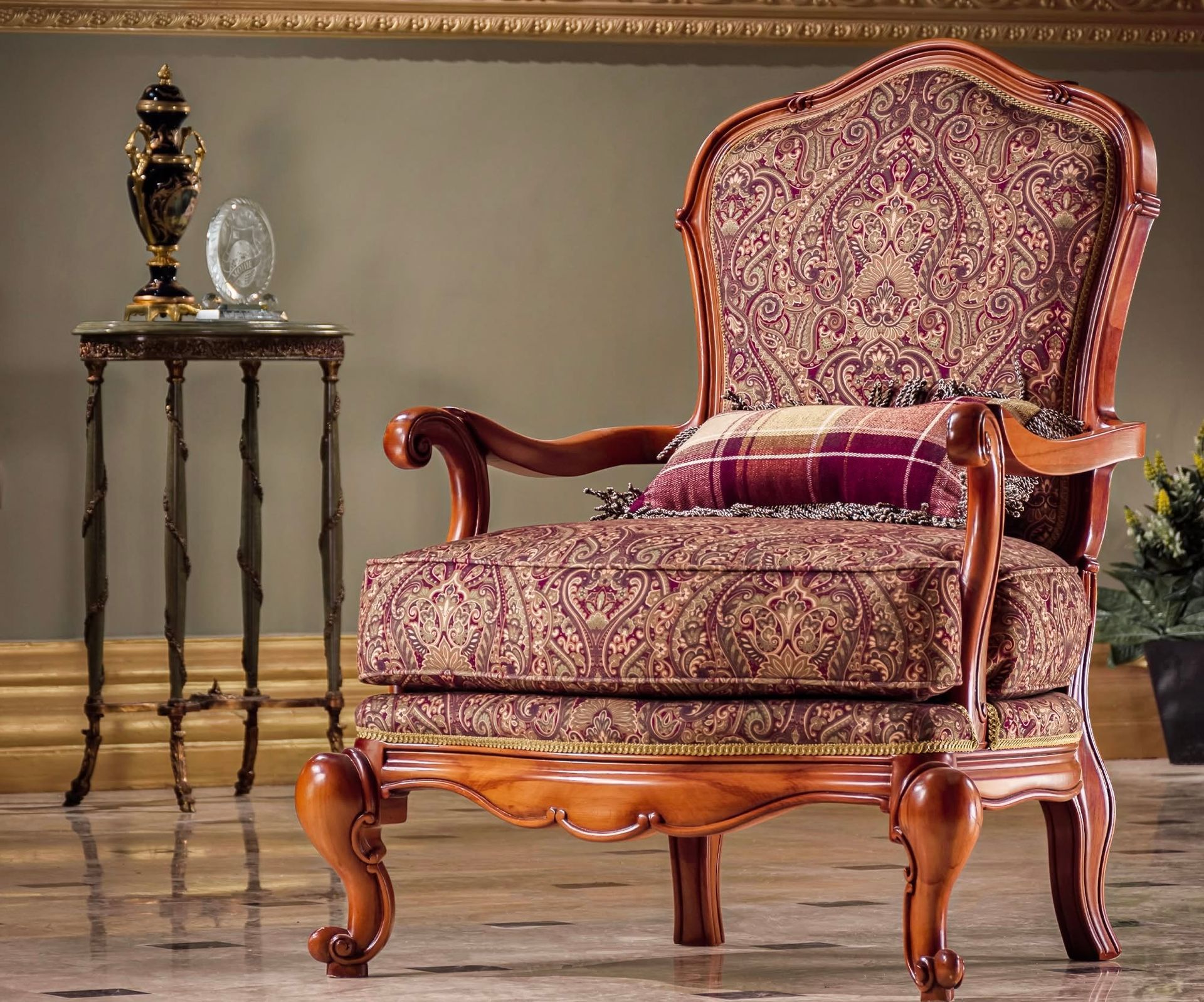 A chair with a pillow on it is next to a small table
