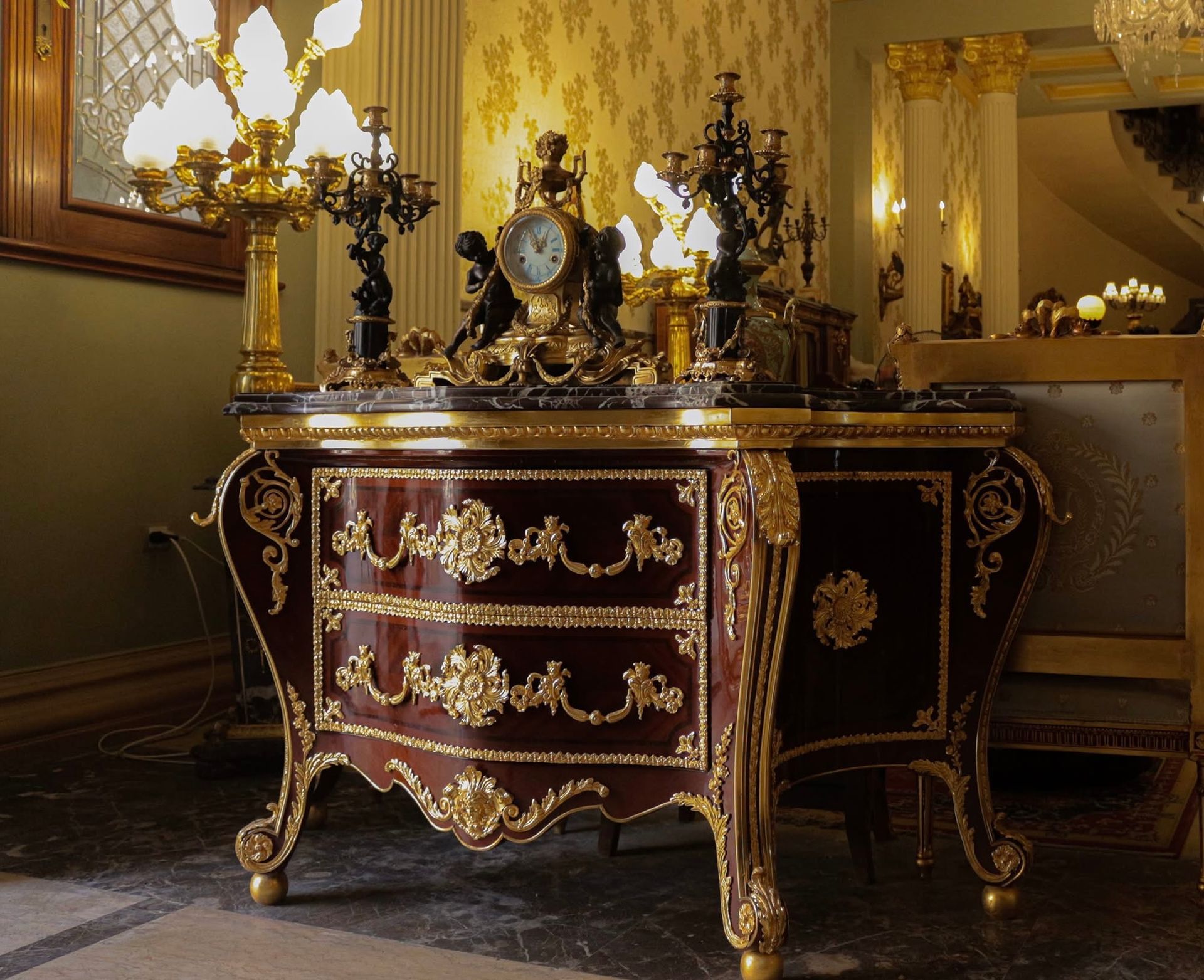 A dresser with a clock on top of it
