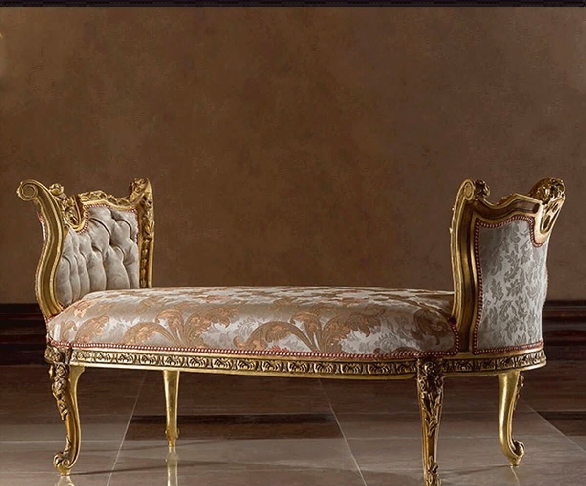 A bench is sitting on a tiled floor in front of a wall.