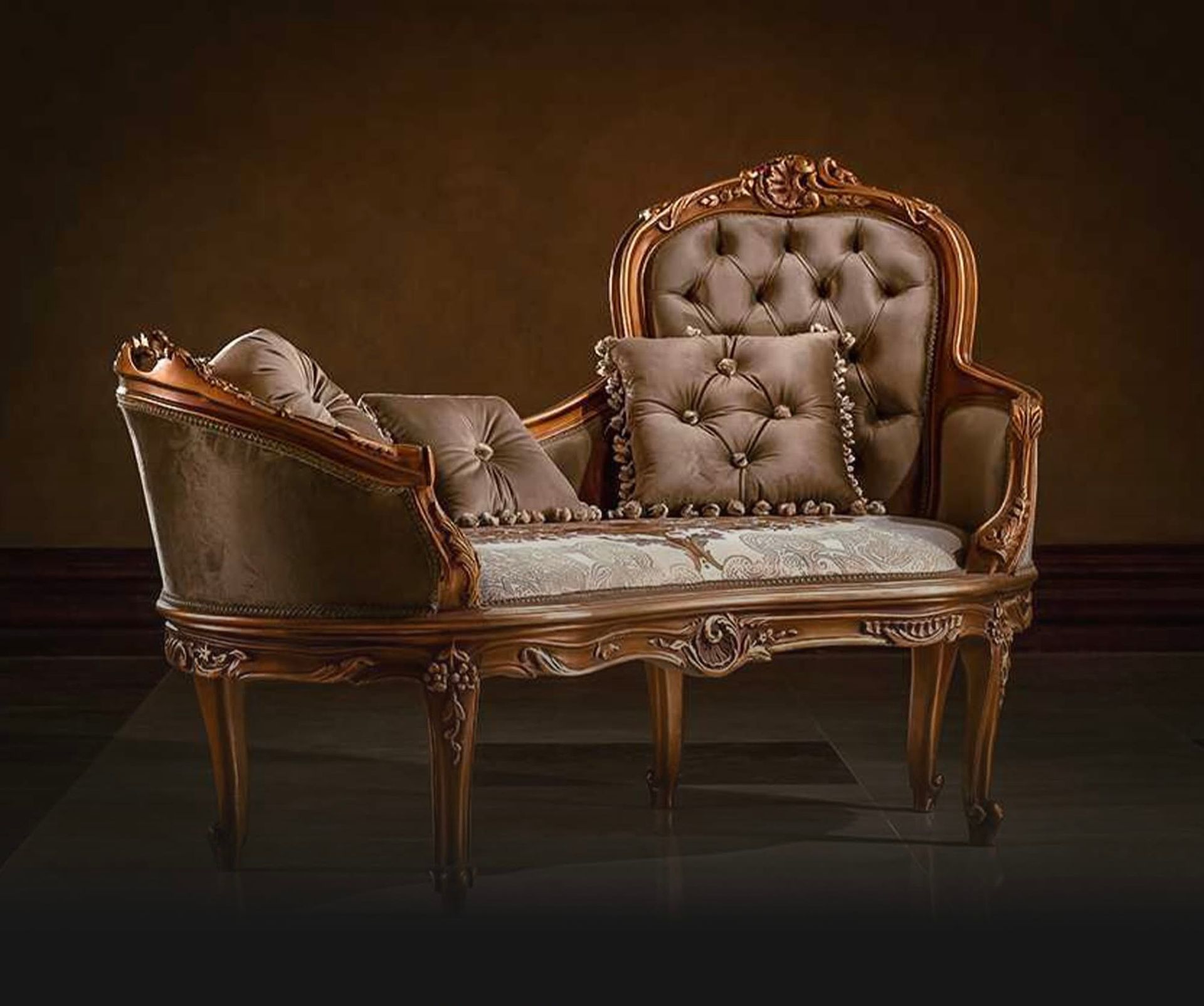 A couch with two pillows on it is sitting in a dark room.