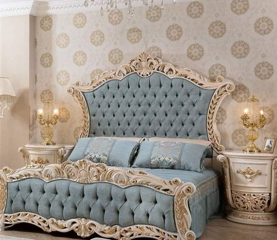 A bedroom with a large bed and two nightstands