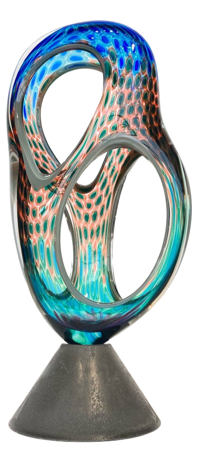 An abstract glass sculpture with blue, teal, and peach honeycomb patterns, mounted on a dark, conical base.