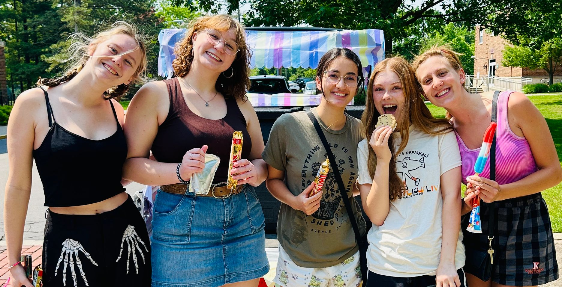 group of students outside on college quad eating ice cream treats