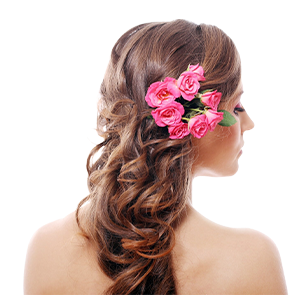 A woman with pink roses in her hair.