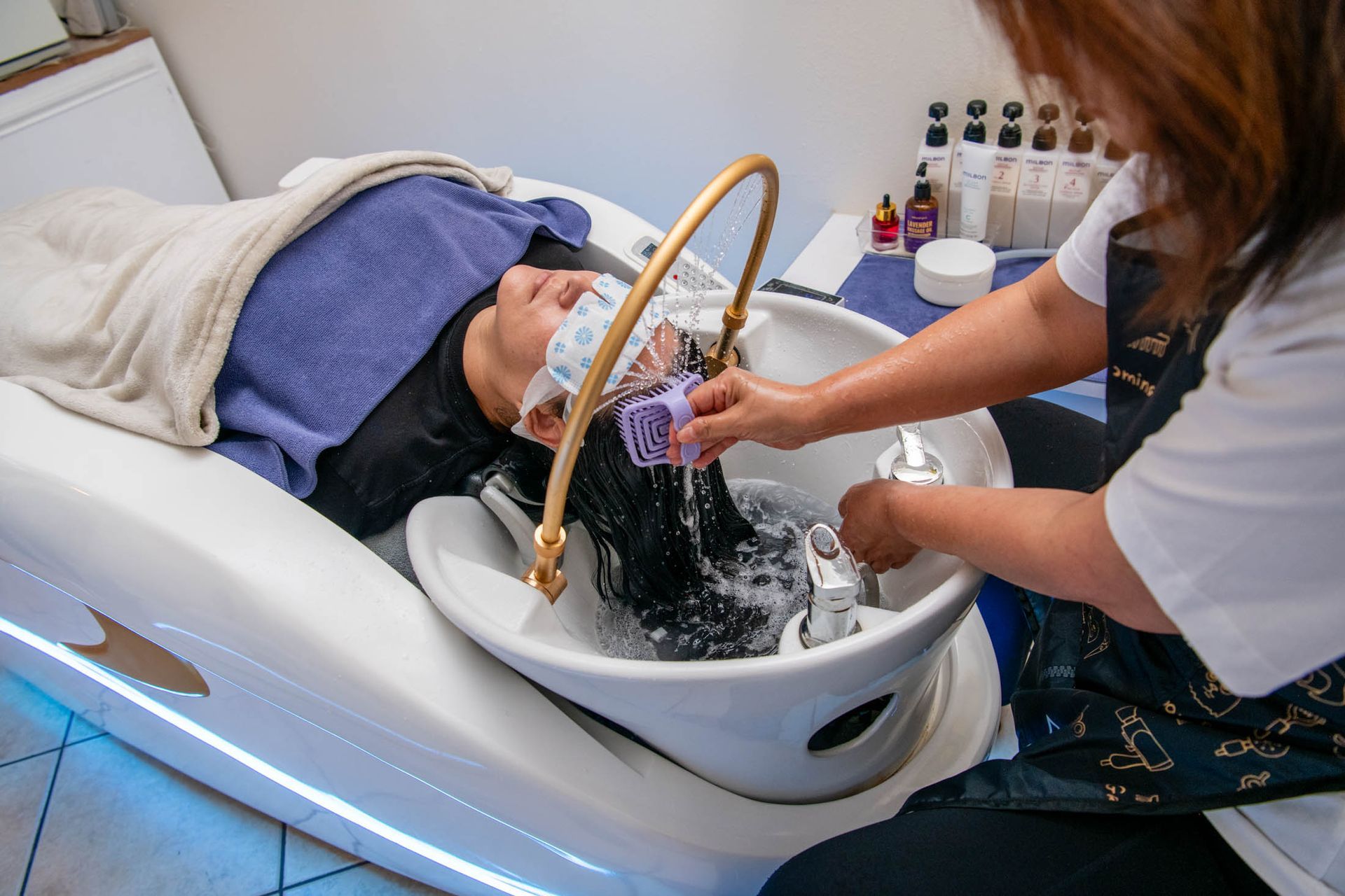 A woman is brushing her hair with a brush.
