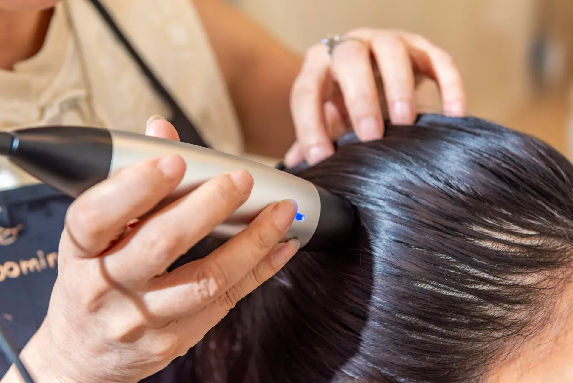 A woman is getting her hair cut by a hairdresser.