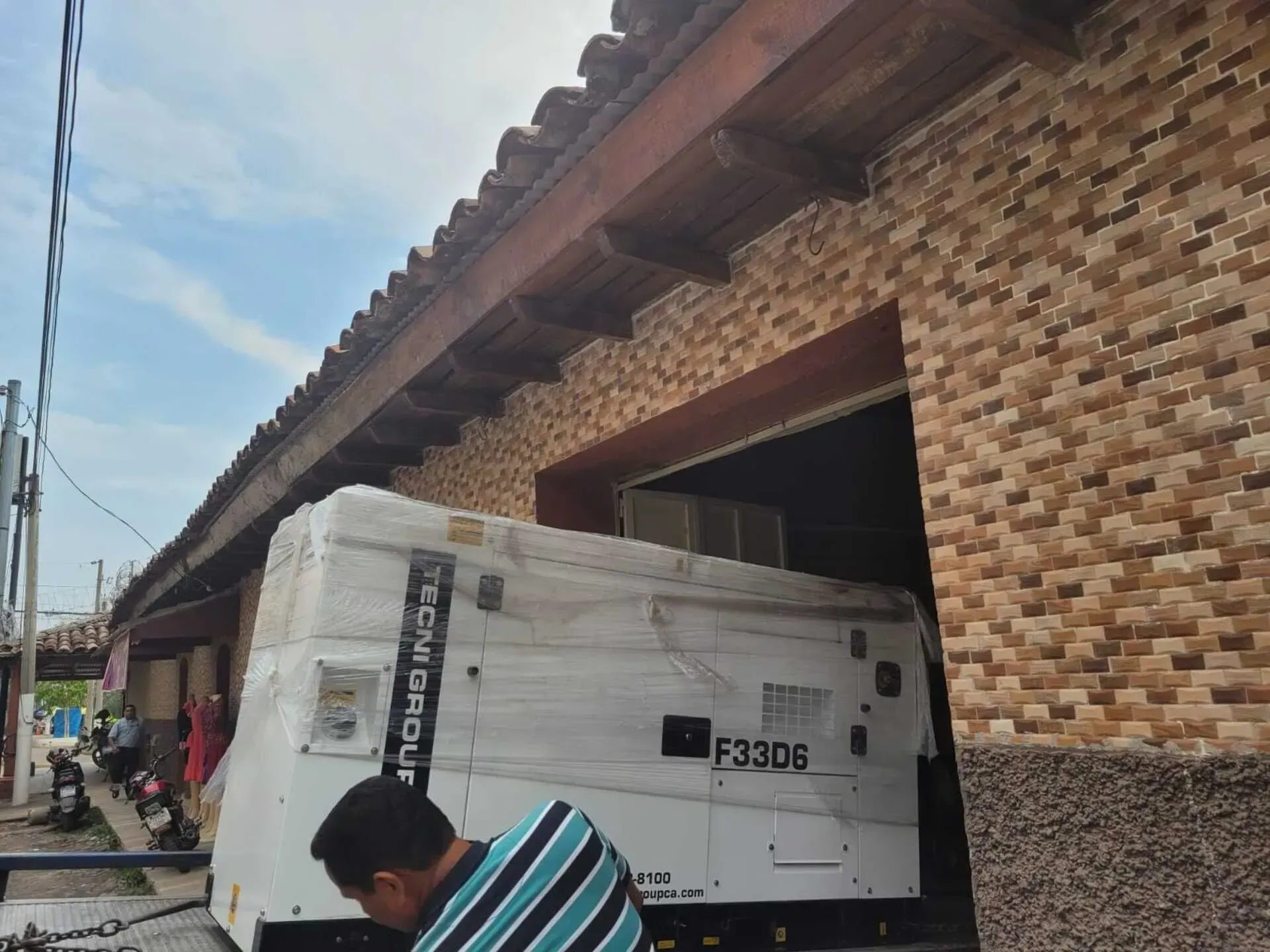 Un hombre está trabajando en un generador que dice f330b