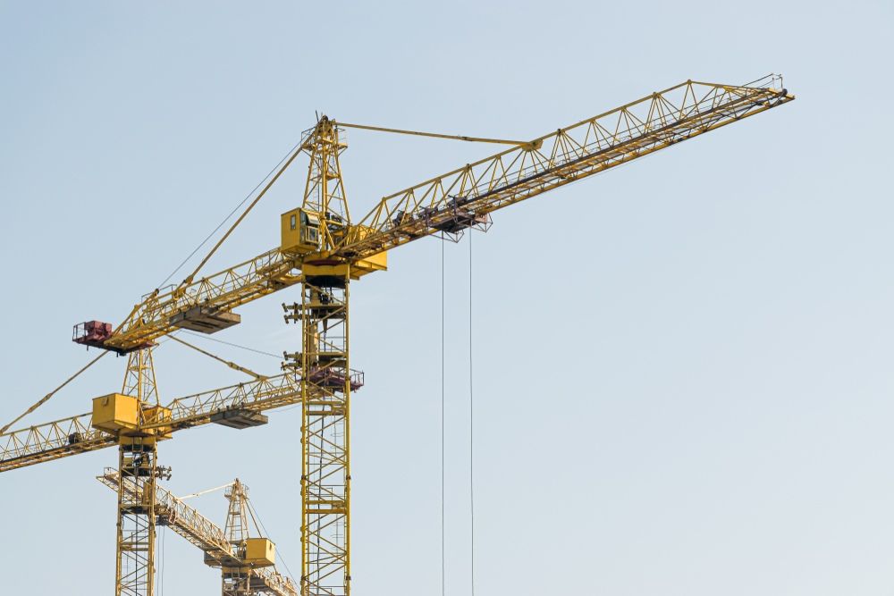 Yellow Construction Cranes Against A Clear Blue Sky — East Coast Cranes in Ormeau, QLD