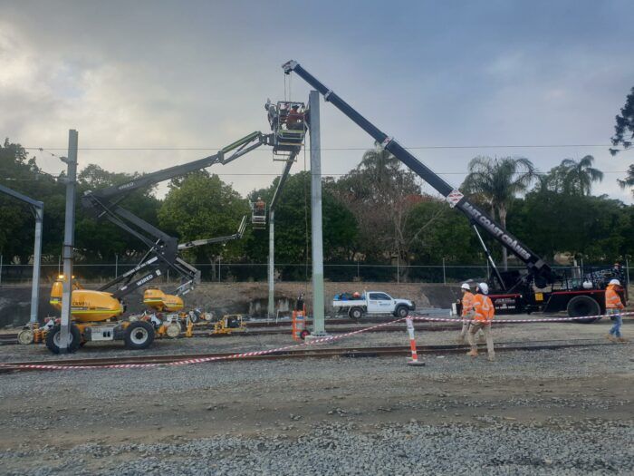 A Crane Is Being Used to Lift a Pole on A Construction Site — East Coast Cranes in Ormeau, QLD
