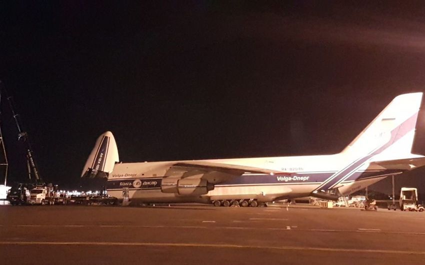 A Large Cargo Plane Is Parked on The Tarmac at Night — East Coast Cranes in Ormeau, QLD