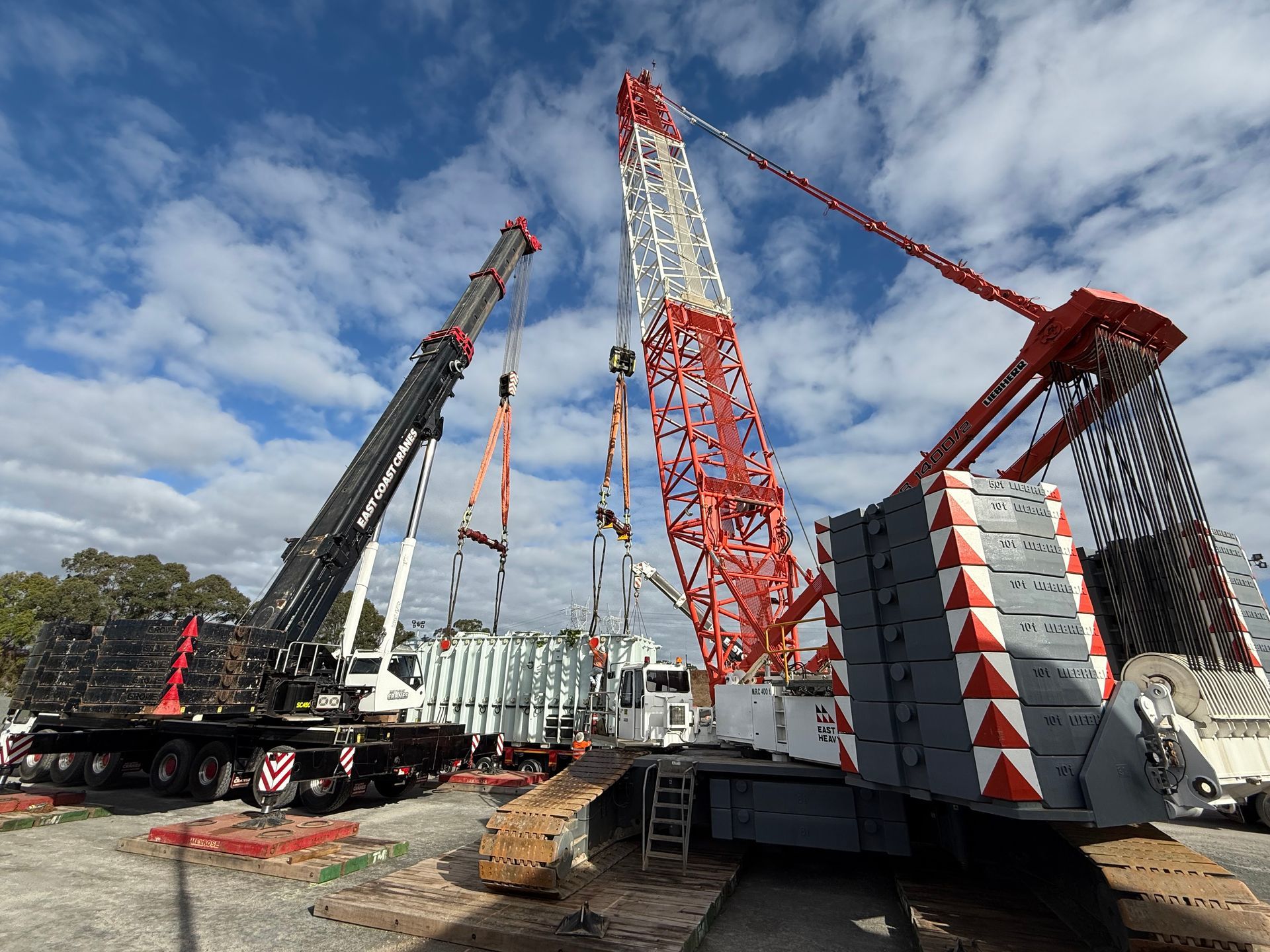Construction crane against a pink cloudy sky — East Coast Cranes in Ormeau, QLD