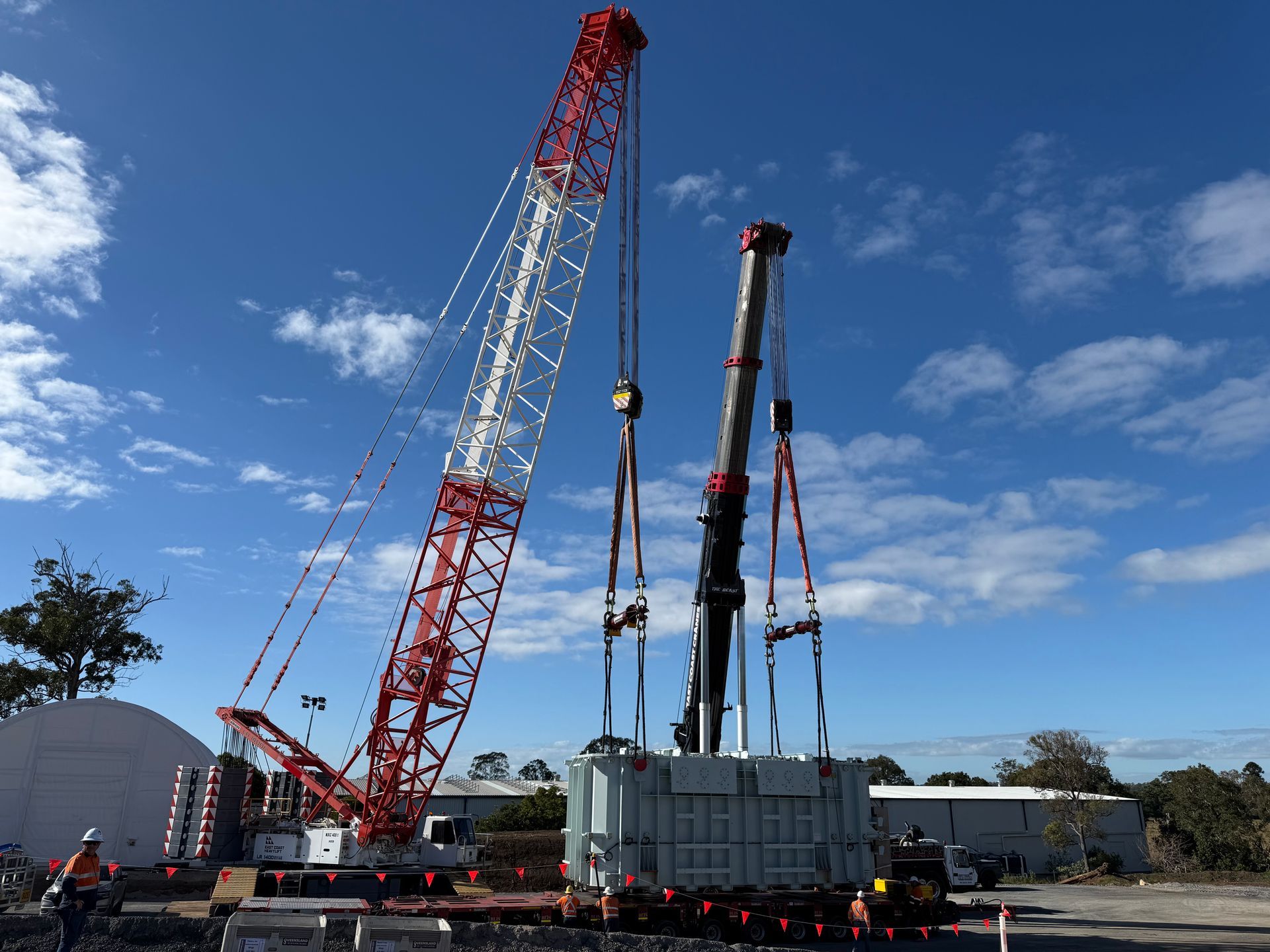 A Large Crane Lifts a Rectangular Transformer Outdoors — East Coast Cranes in Ormeau, QLD