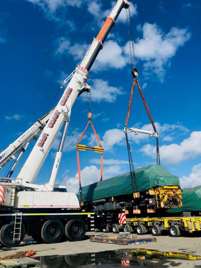 A Large Crane Is Lifting a Large Piece of Equipment — East Coast Cranes in Ormeau, QLD