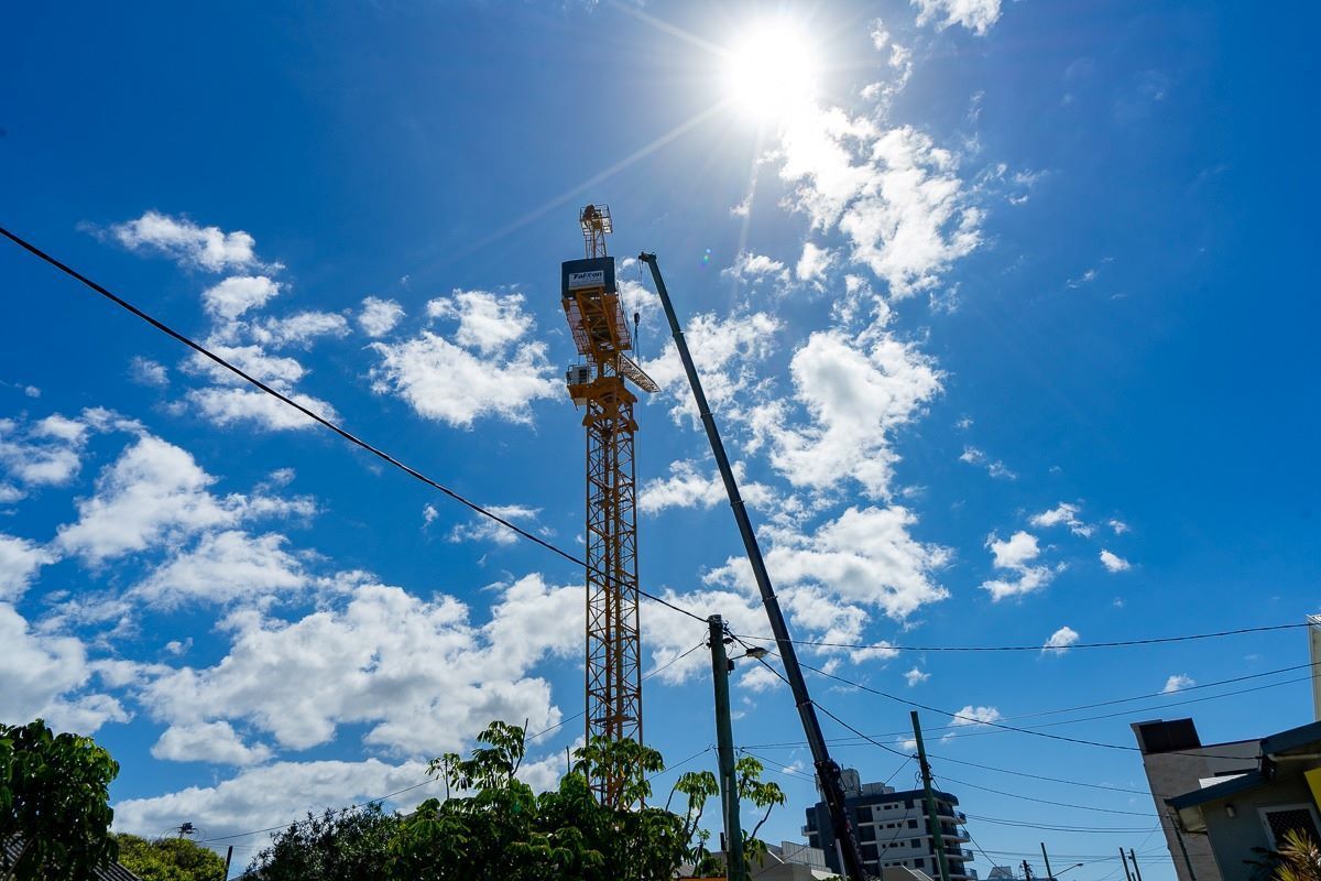 A Construction Crane Is Being Built in A City on A Sunny Day — East Coast Cranes in Ormeau, QLD