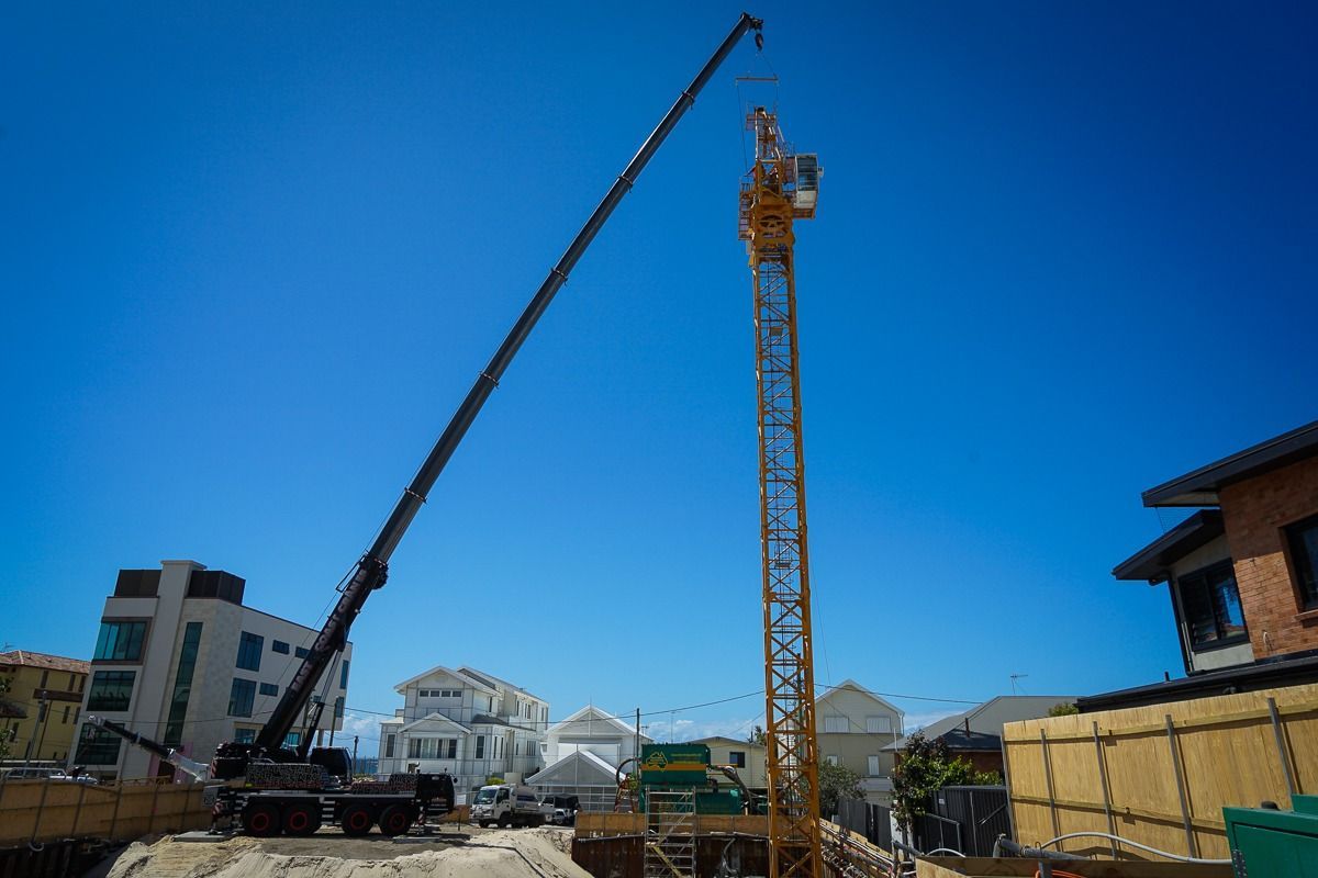 A Construction Site with A Crane and A Building in The Background — East Coast Cranes in Ormeau, QLD