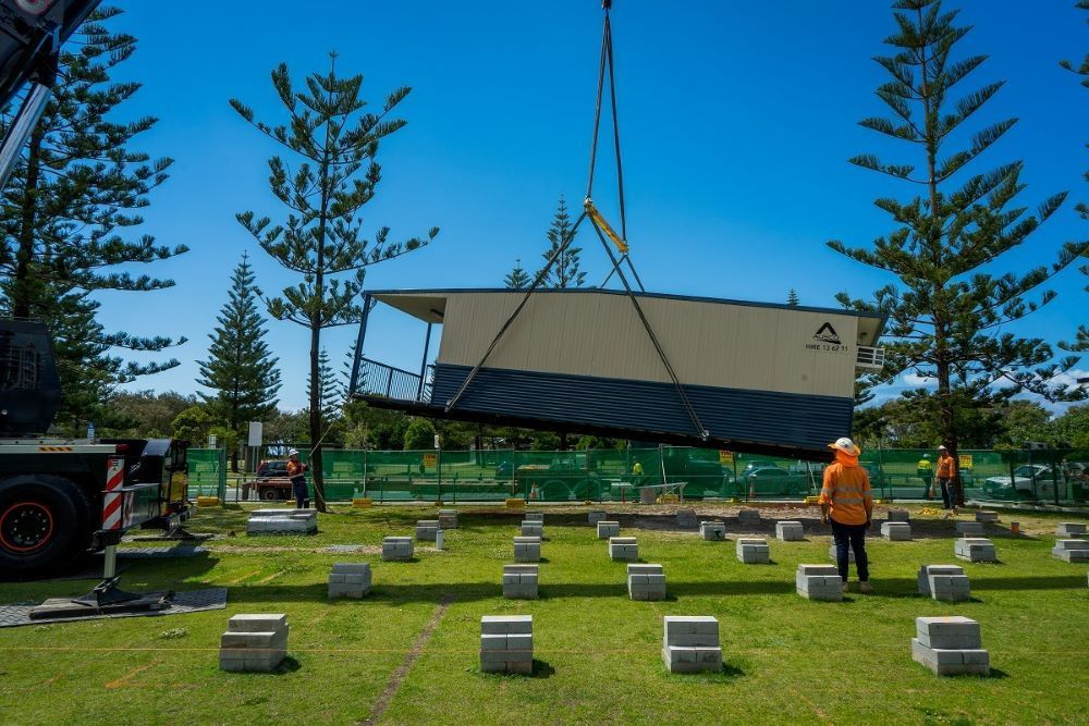 A Crane Is Lifting a Building Into the Ground — East Coast Cranes in Ormeau, QLD