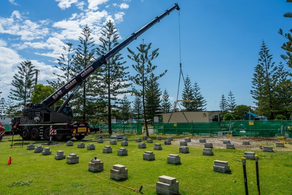 A Large Crane Is Lifting Concrete Blocks in A Field — East Coast Cranes in Ormeau, QLD
