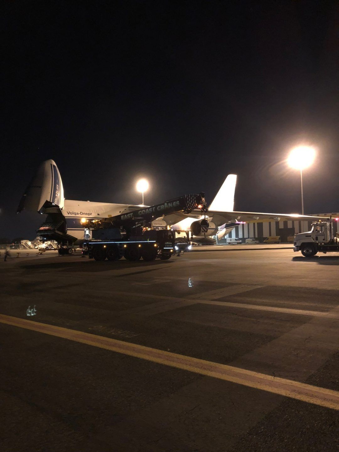 A Large Airplane Is Parked on The Tarmac at Night — East Coast Cranes in Ormeau, QLD
