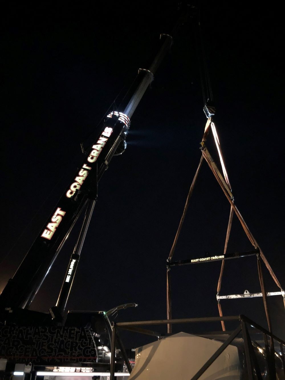 A Large East Coast Crane Is Lit up At Night — East Coast Cranes in Ormeau, QLD
