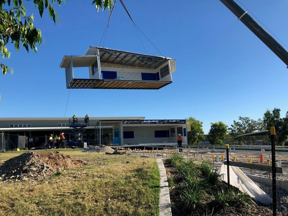 A House Is Being Lifted Into the Air by A Crane — East Coast Cranes in Ormeau, QLD