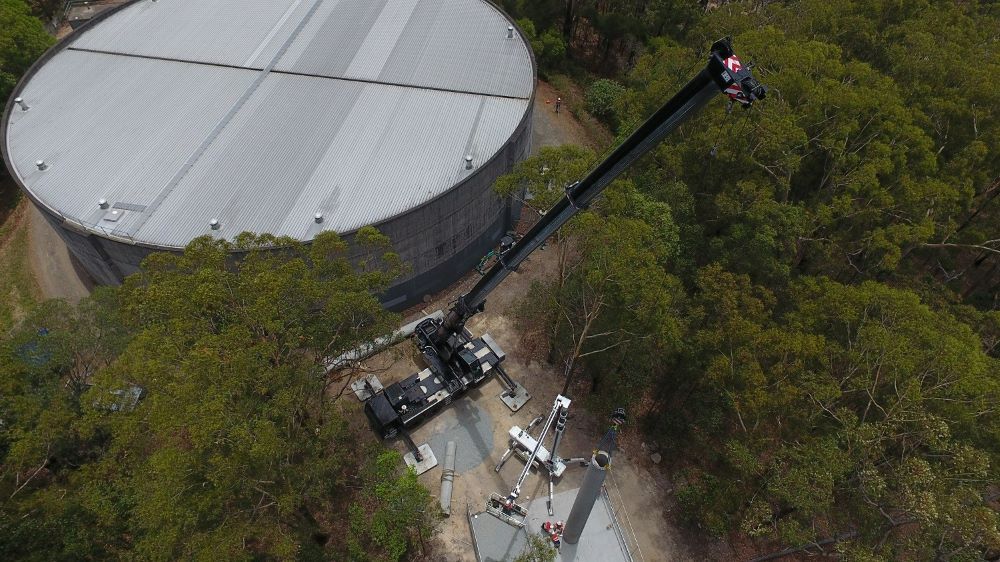 An Aerial View of A Large Water Tank Surrounded by Trees — East Coast Cranes in Ormeau, QLD