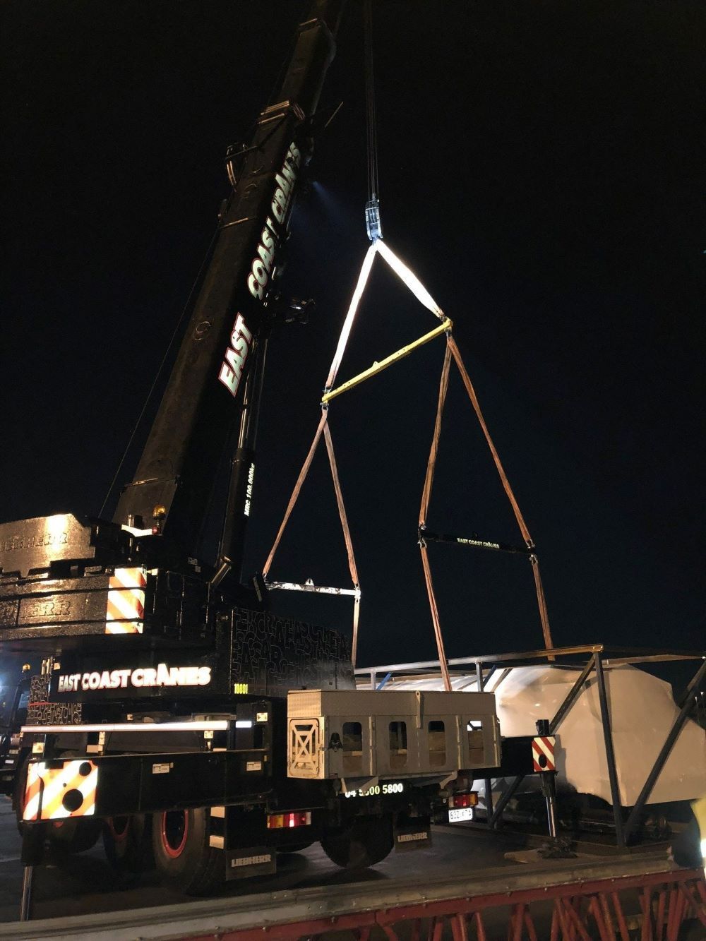 A Large East Crane Is Lifting a Large Object — East Coast Cranes in Ormeau, QLD