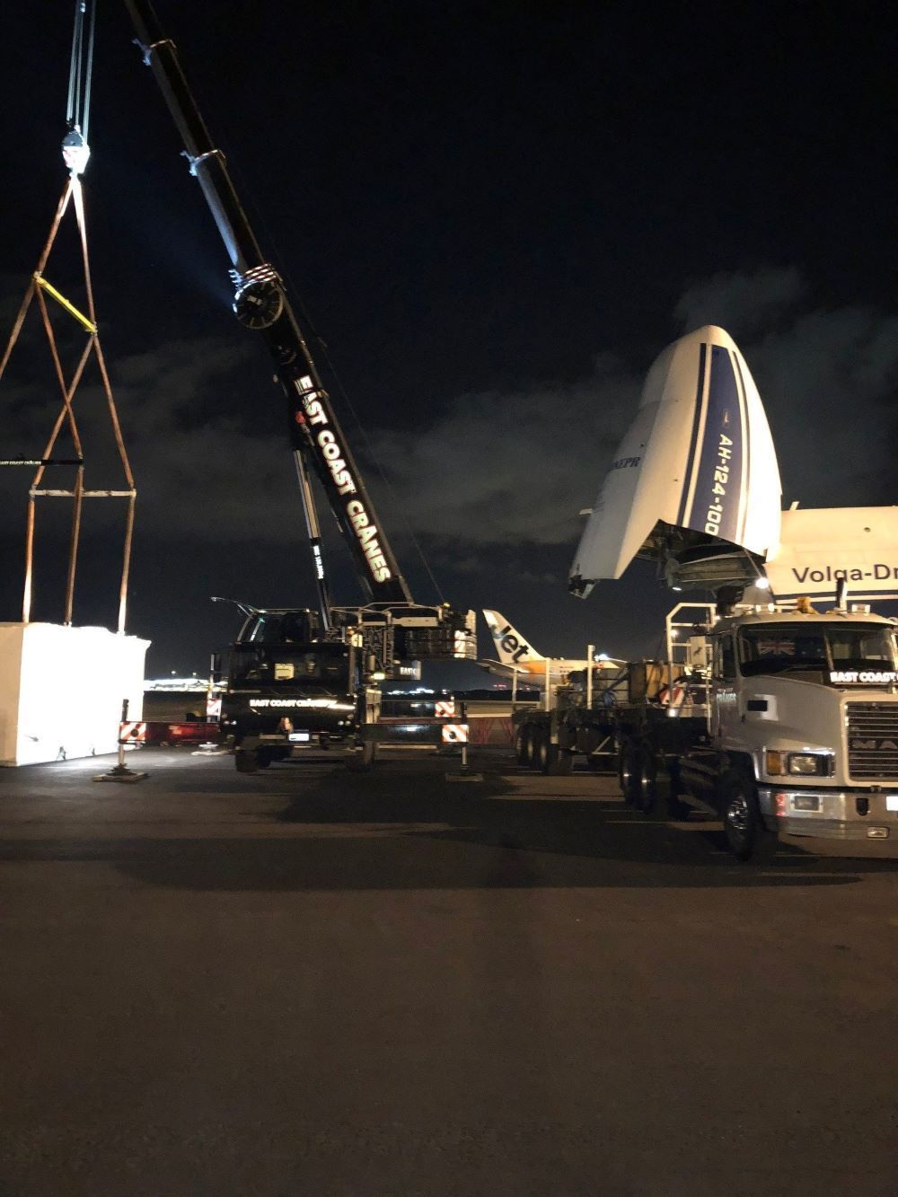 A Large Plane Is Being Lifted Into the Air by A Crane — East Coast Cranes in Ormeau, QLD