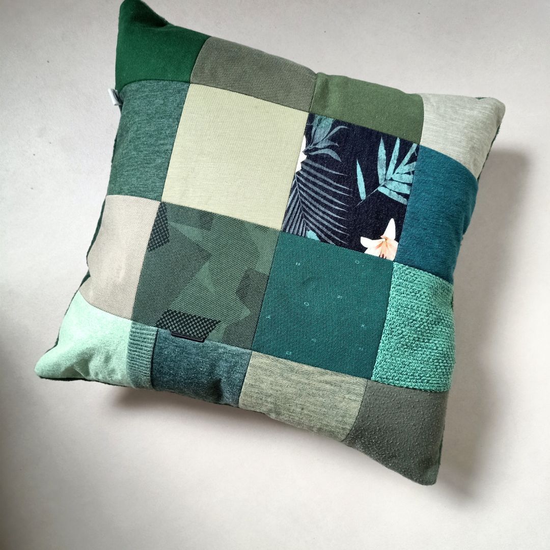 Een groen kussen met een bloemenpatroon erop