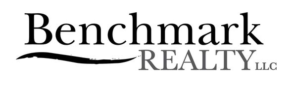 Benchmark Realty LLC logo in black and gray text with a wave underline