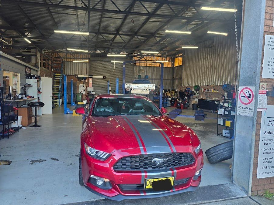 A Red Mustang Is Parked In A Garage — Nuron Inspection & Service Centre In Broadmeadow, NSW