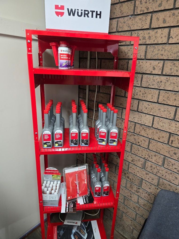 A Red Shelf Filled With Bottles Of Wurth Products — Nuron Inspection & Service Centre In Broadmeadow, NSW