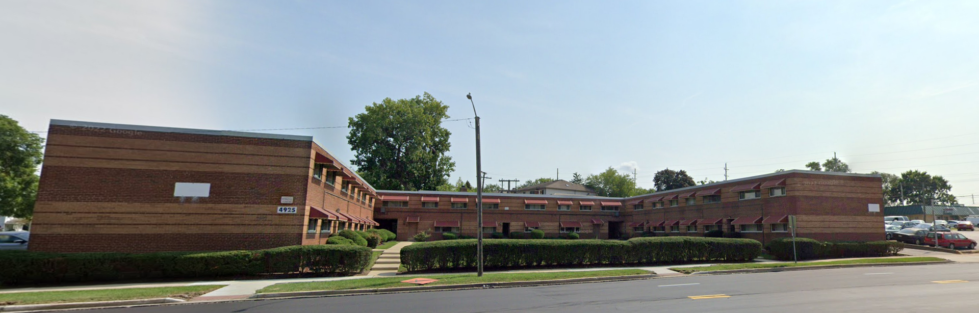 a large brick building with a blue sky in the background