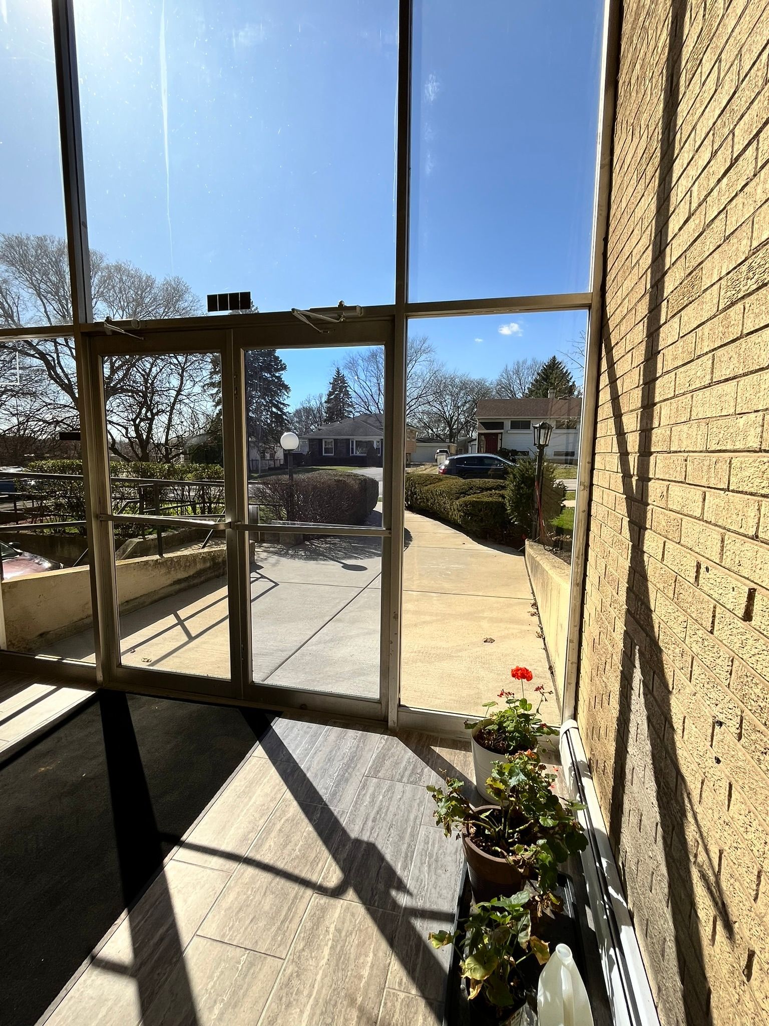 a room with a lot of windows and a brick wall .