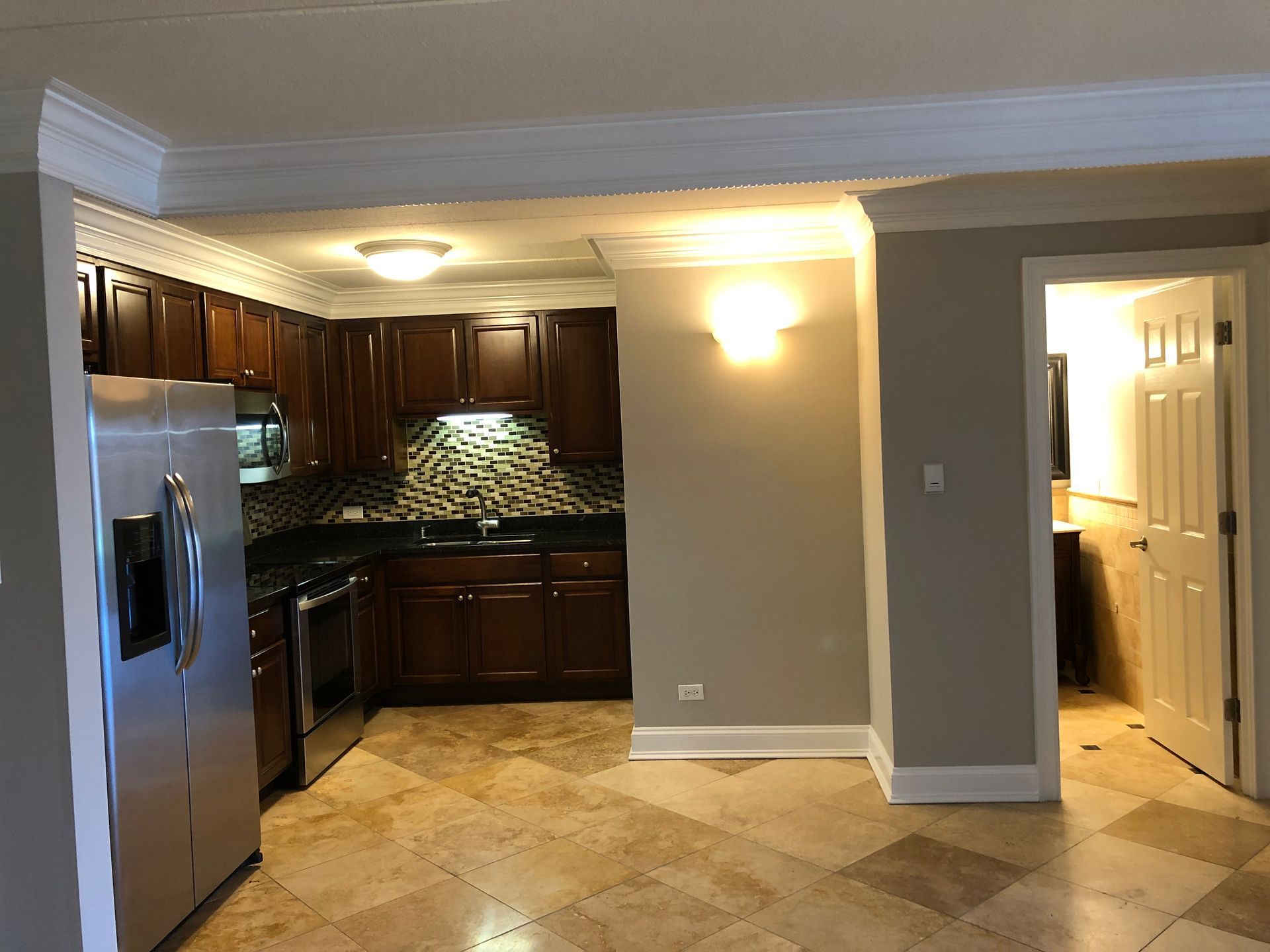 A kitchen with stainless steel appliances and wooden cabinets