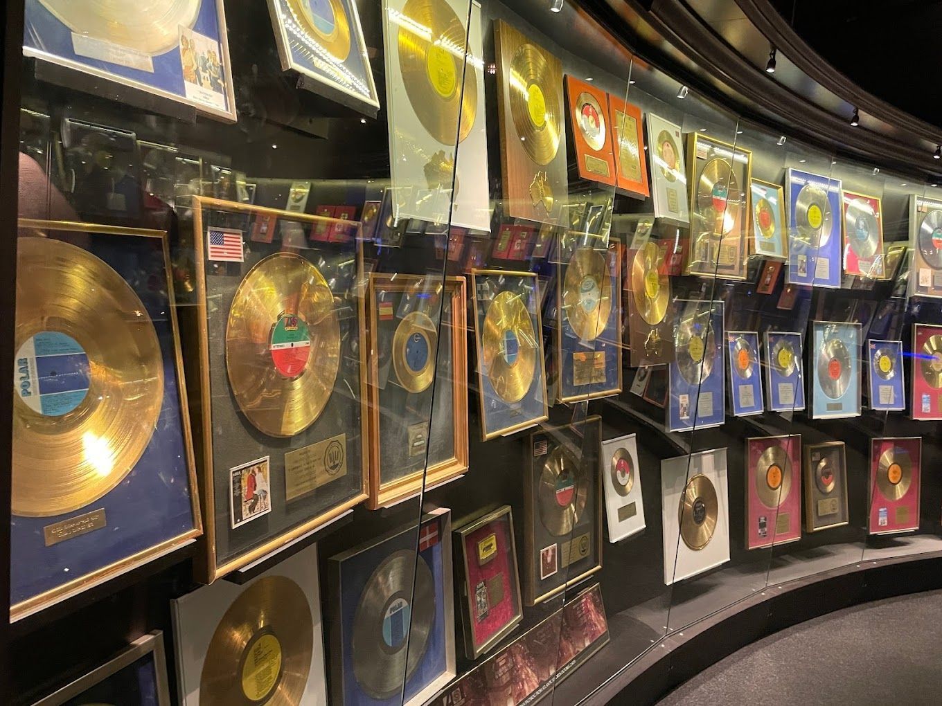 a wall with a lot of gold records on it
