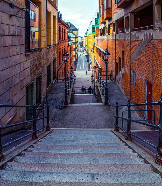 a narrow street with stairs leading up to a building