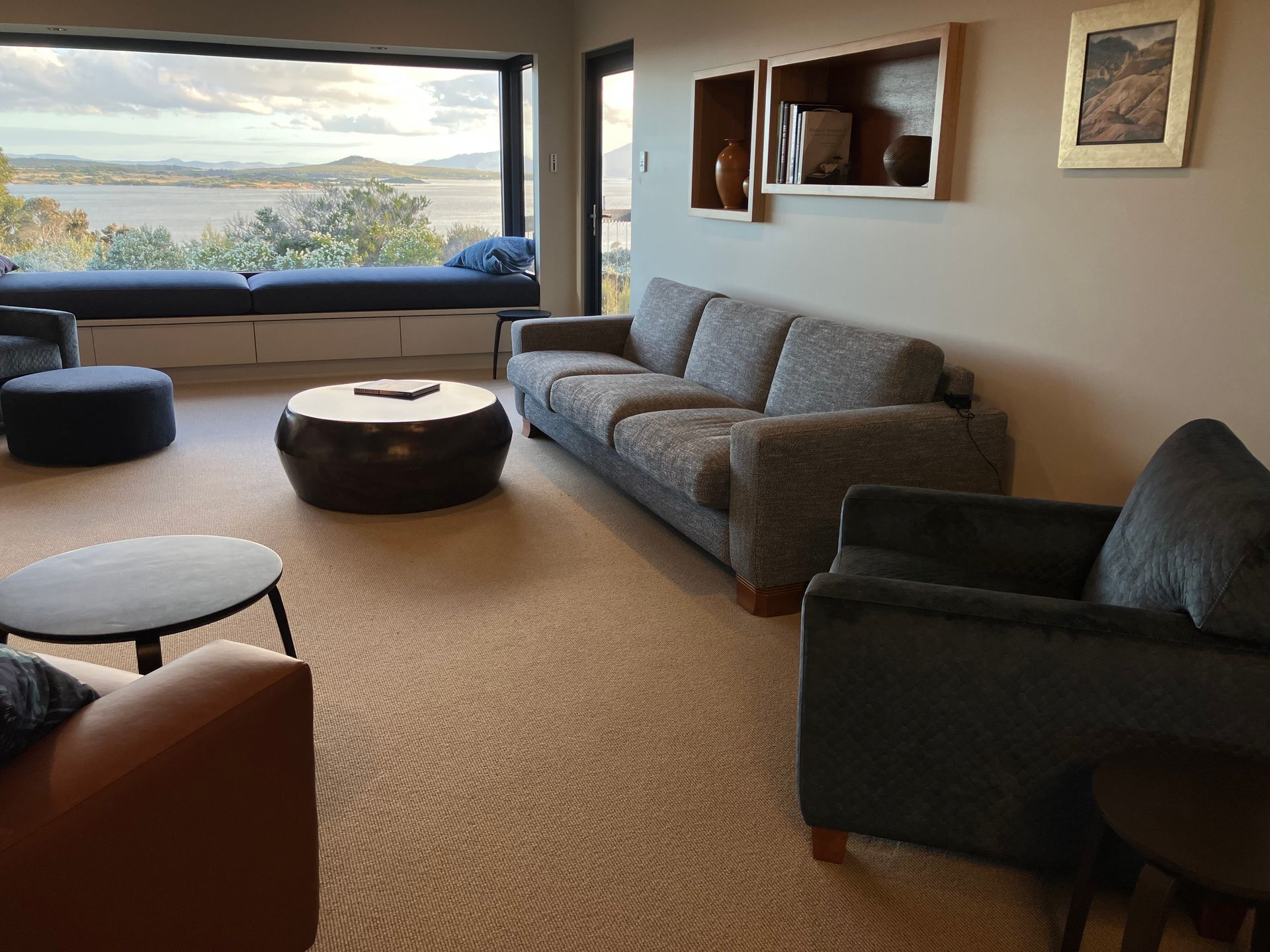 Living room in faraway with big comfy couch and view out to sea