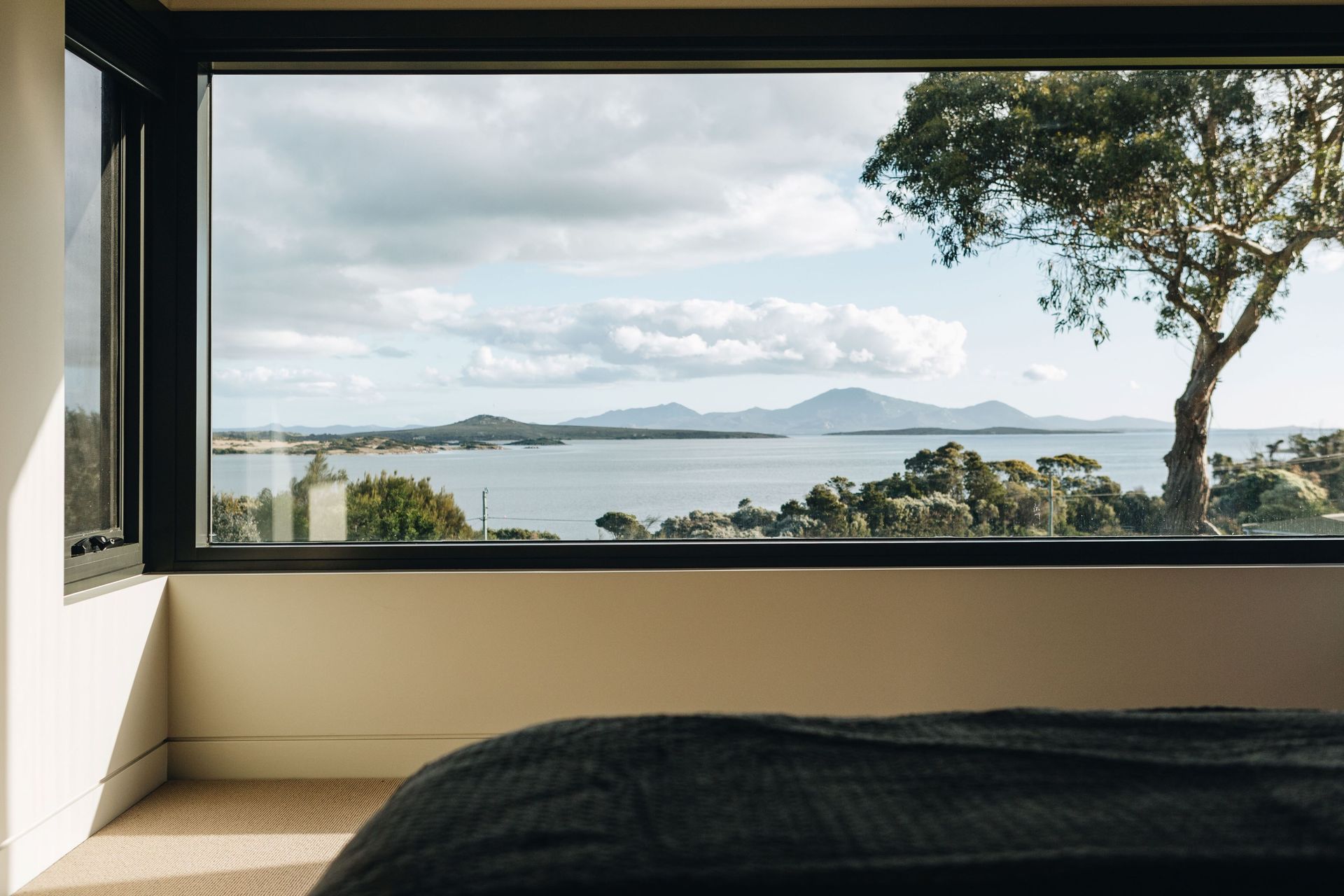 View from inside, looking out through the living room window to the ocean and islands