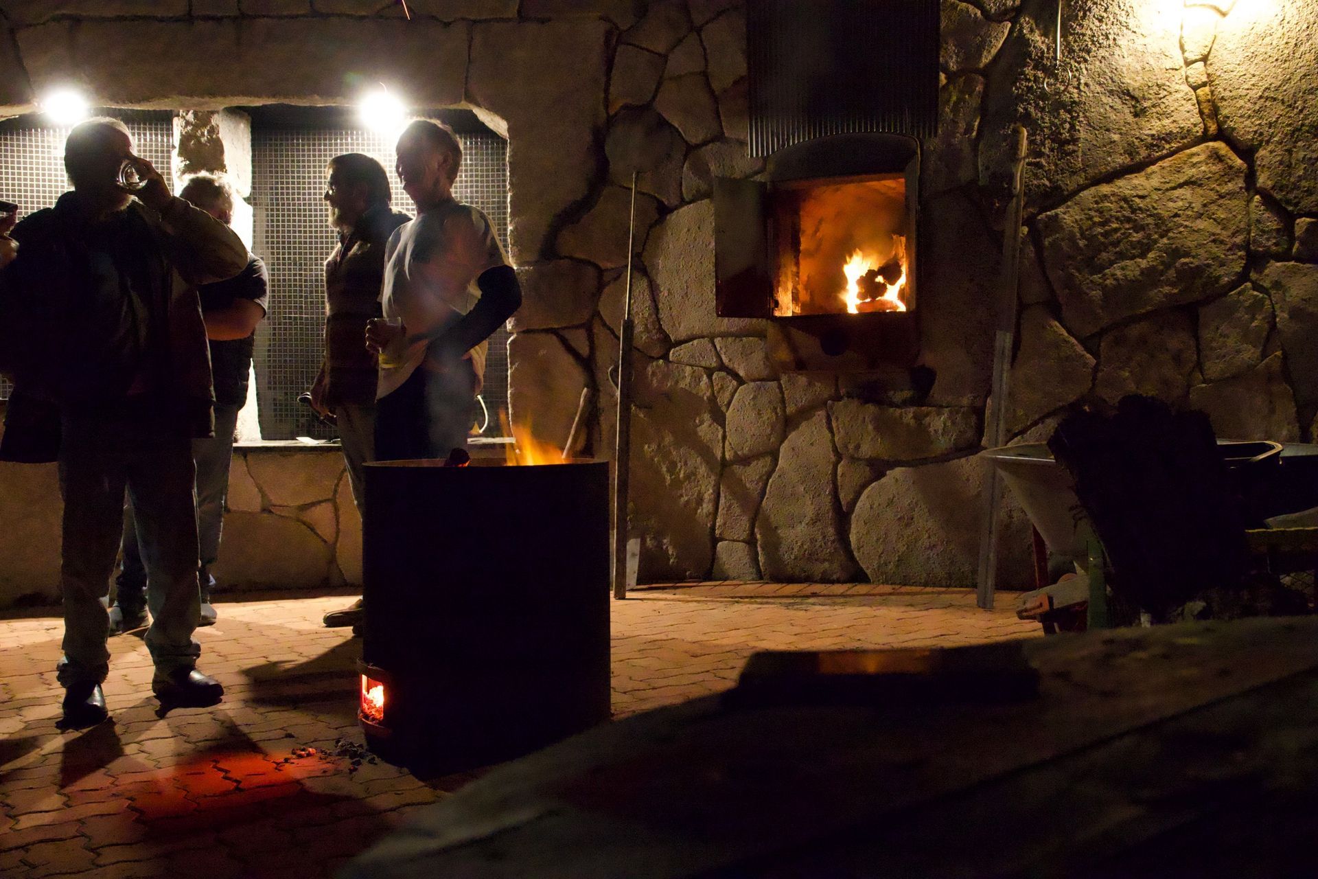 A group of people standing in front of a fireplace in the Faraway courtyard