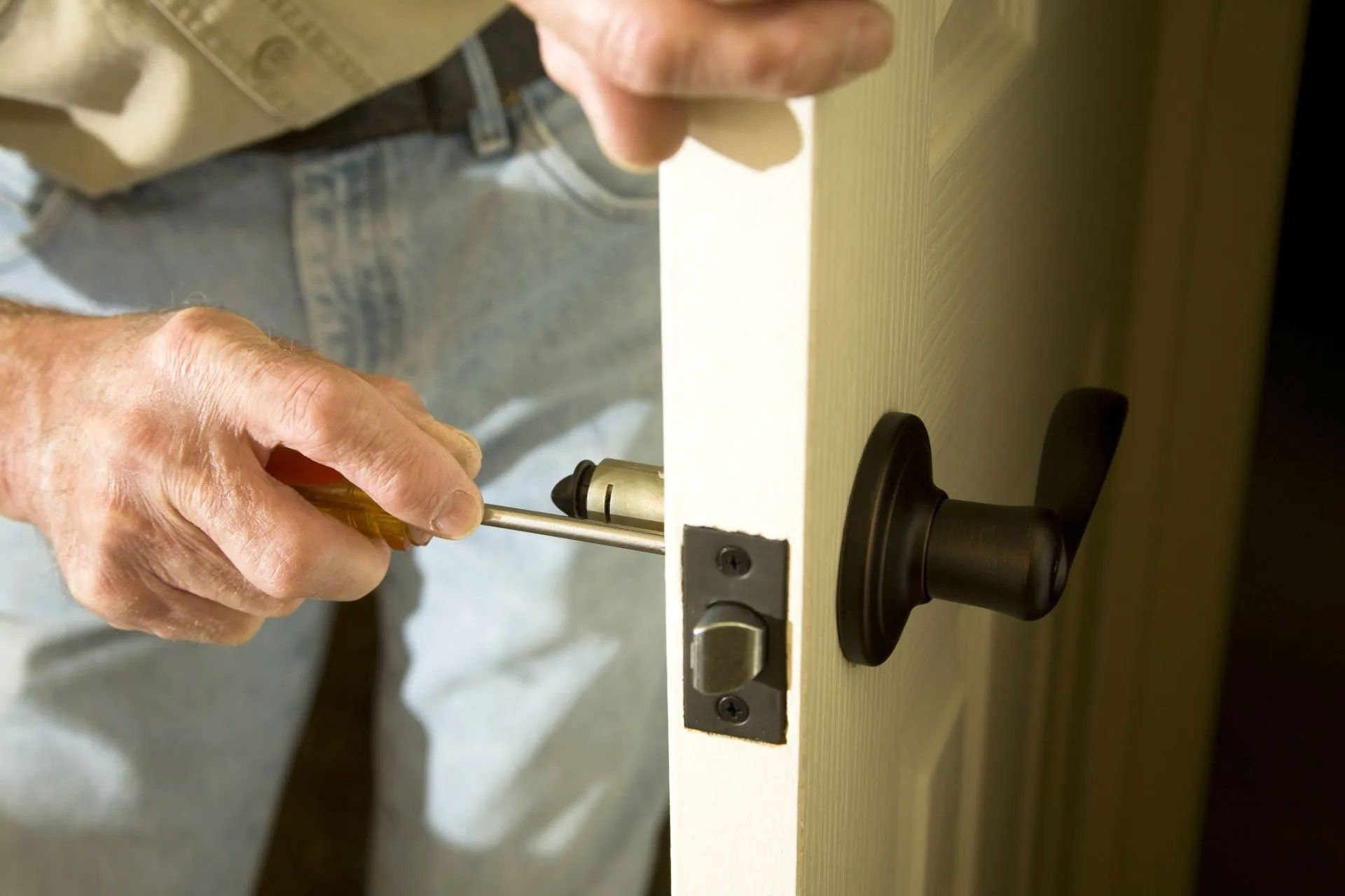 Man repairing door knob