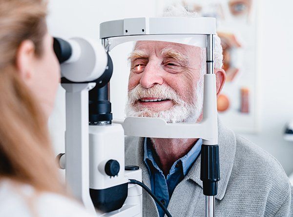 Smiling Cheerful Elderly Patient Being Checked On Eye — Warren, MI — Professional Family Eyecare