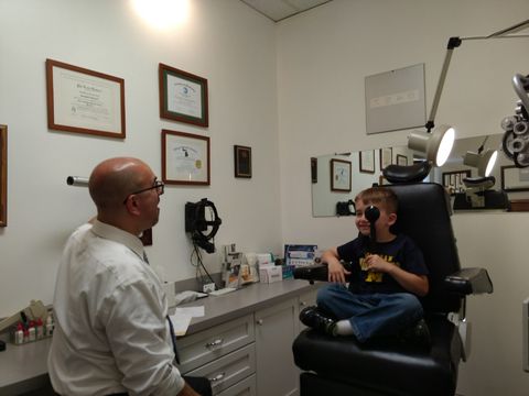 Eye Doctor With Female Patient During An Examination — Warren, MI — Professional Family Eyecare