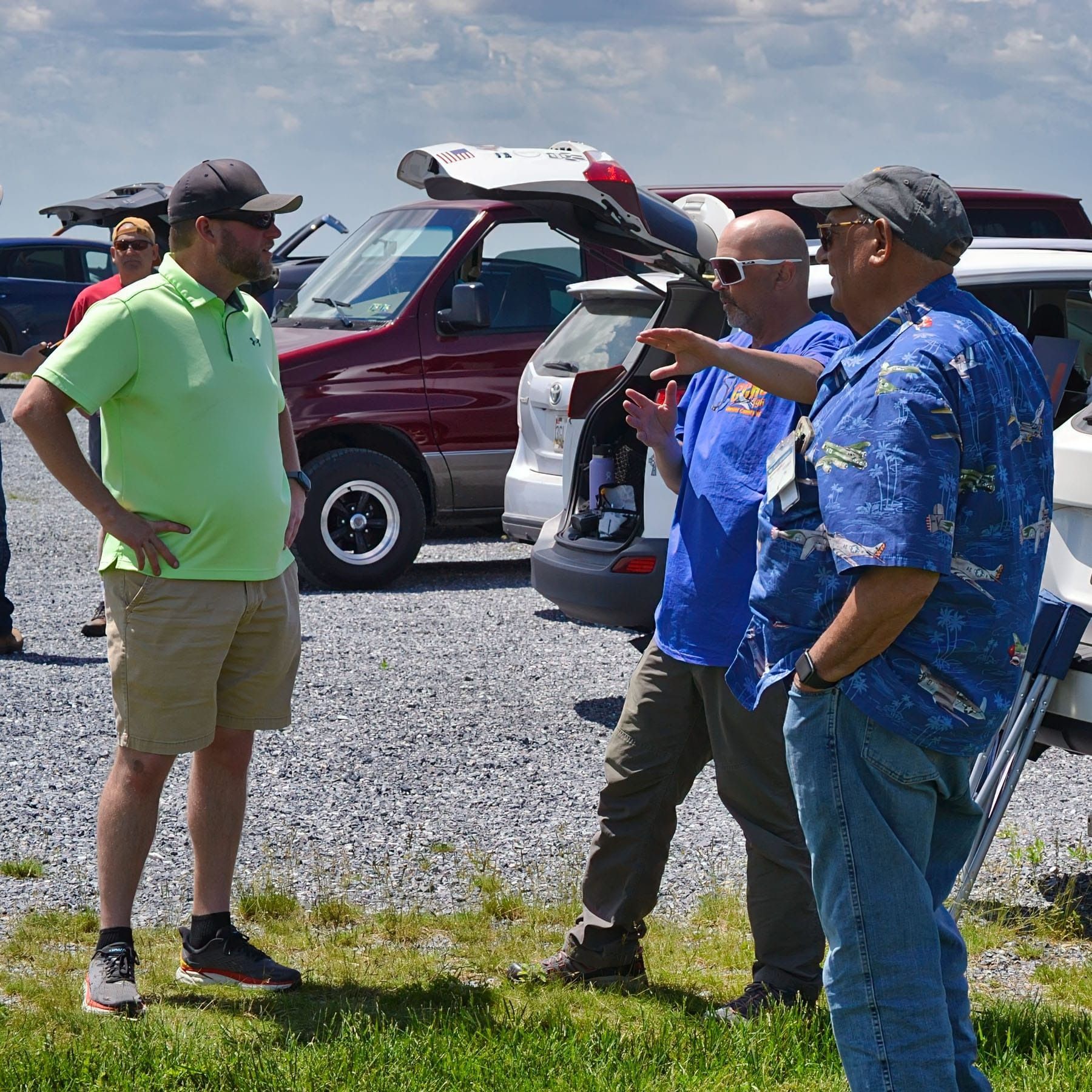 People cutting a yellow ribbon under a green-roofed structure, signaling an opening.