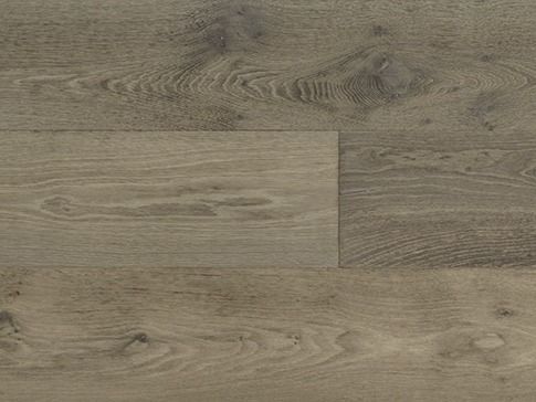Close-up of weathered gray-brown wood flooring with visible grain patterns and knots.